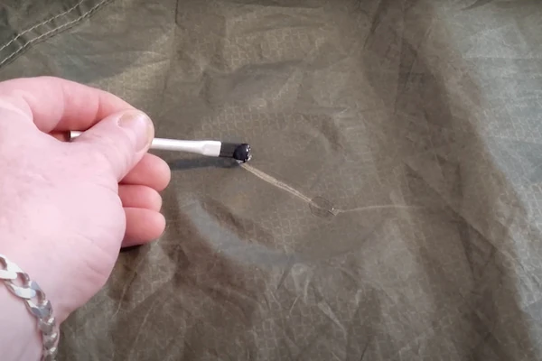 applying-glue-to-tent
